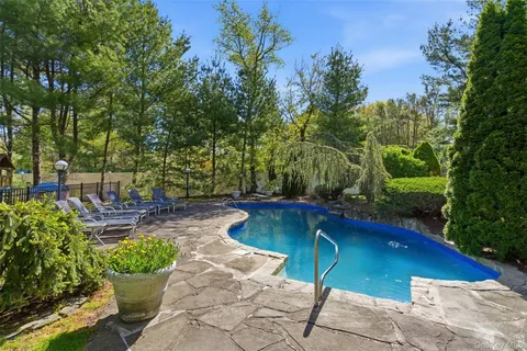 a view of a backyard with chairs