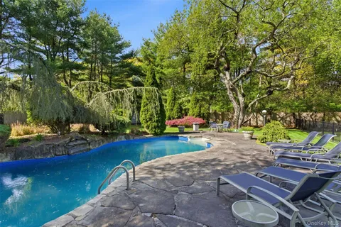 a view of backyard with wooden fence
