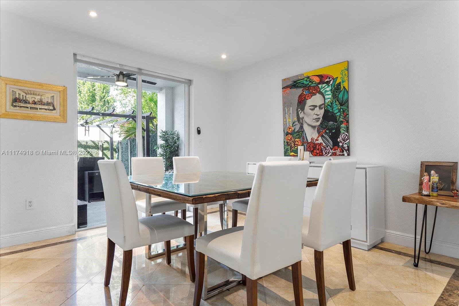 Doral Isles Doral, FL 33178 - Photo 12 of 38 a view of a dining room with furniture a rug and wooden floor