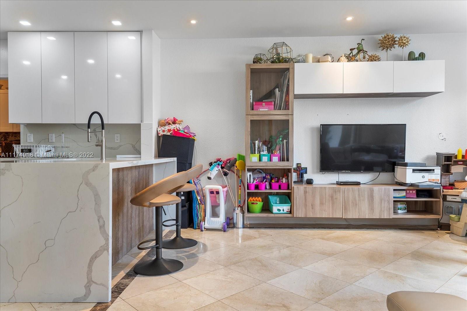 Doral Isles Doral, FL 33178 - Photo 14 of 38 a living room with furniture and a flat screen tv