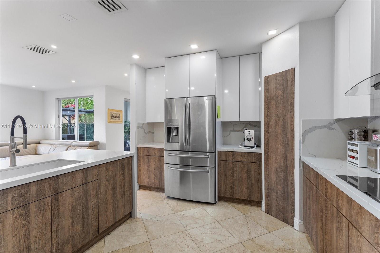 Doral Isles Doral, FL 33178 - Photo 17 of 38 a kitchen with a sink stainless steel appliances and cabinets