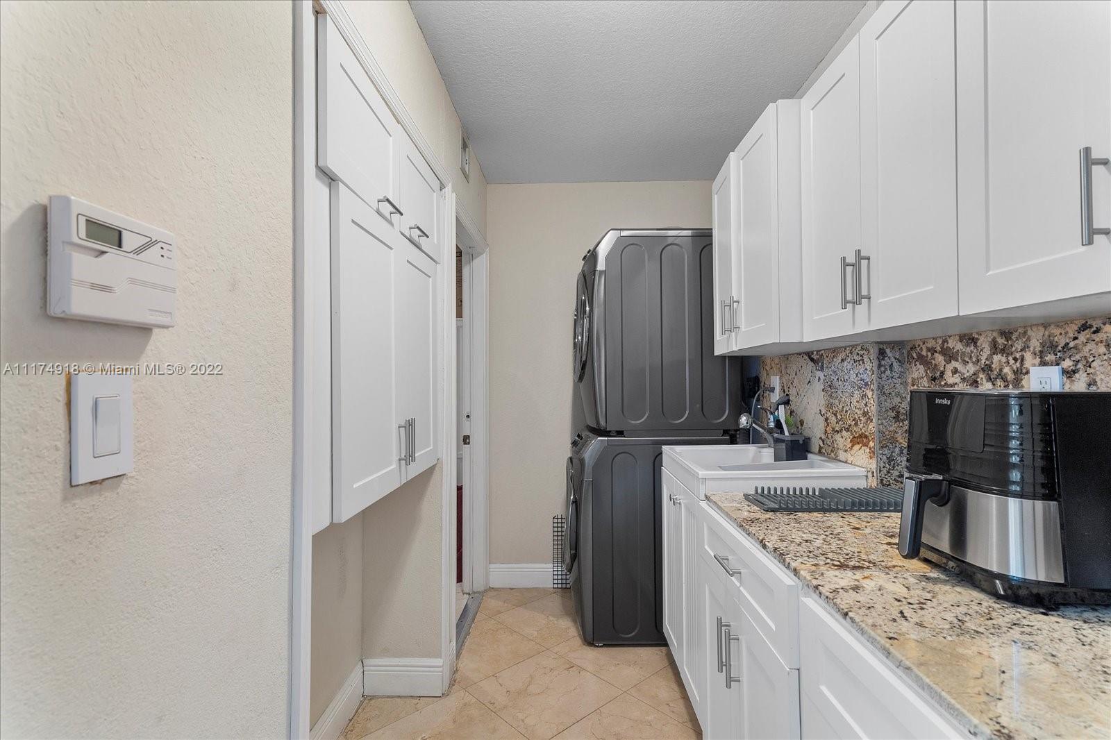Doral Isles Doral, FL 33178 - Photo 19 of 38 a kitchen with stainless steel appliances granite countertop a refrigerator and a stove