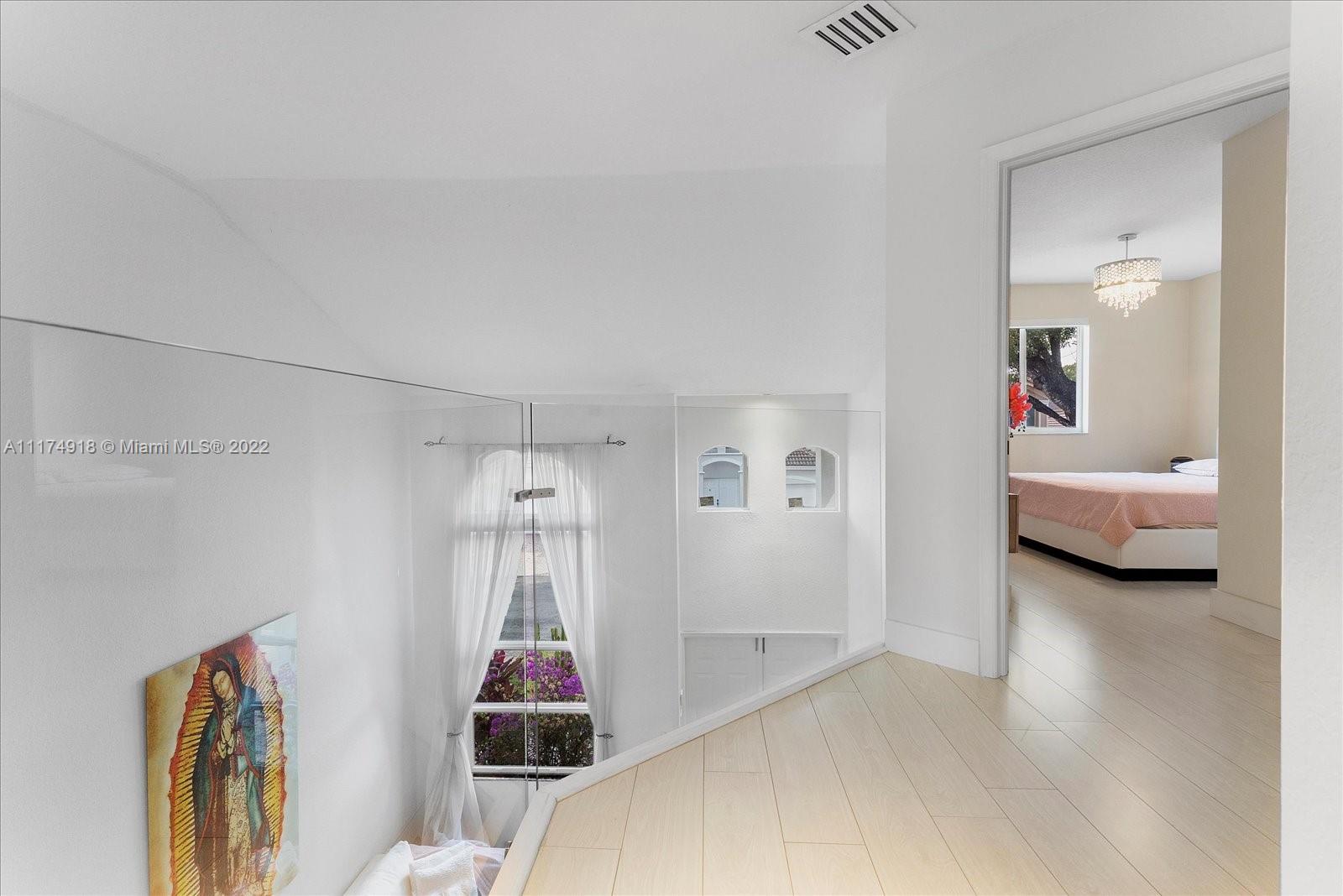 Doral Isles Doral, FL 33178 - Photo 22 of 38 a bed room with a bed and a window