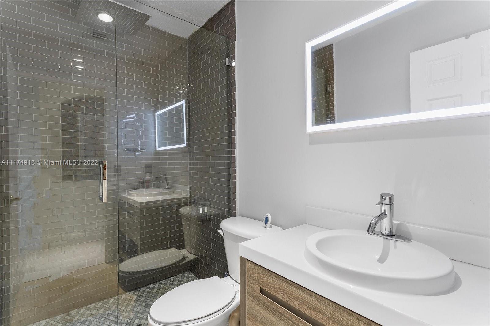 Doral Isles Doral, FL 33178 - Photo 26 of 38 a bathroom with a sink toilet and shower