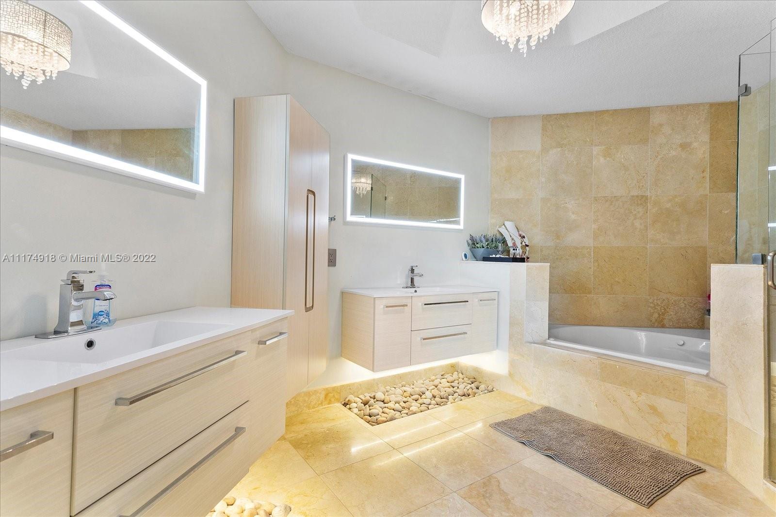 Doral Isles Doral, FL 33178 - Photo 29 of 38 a spacious bathroom with a tub sink and mirror