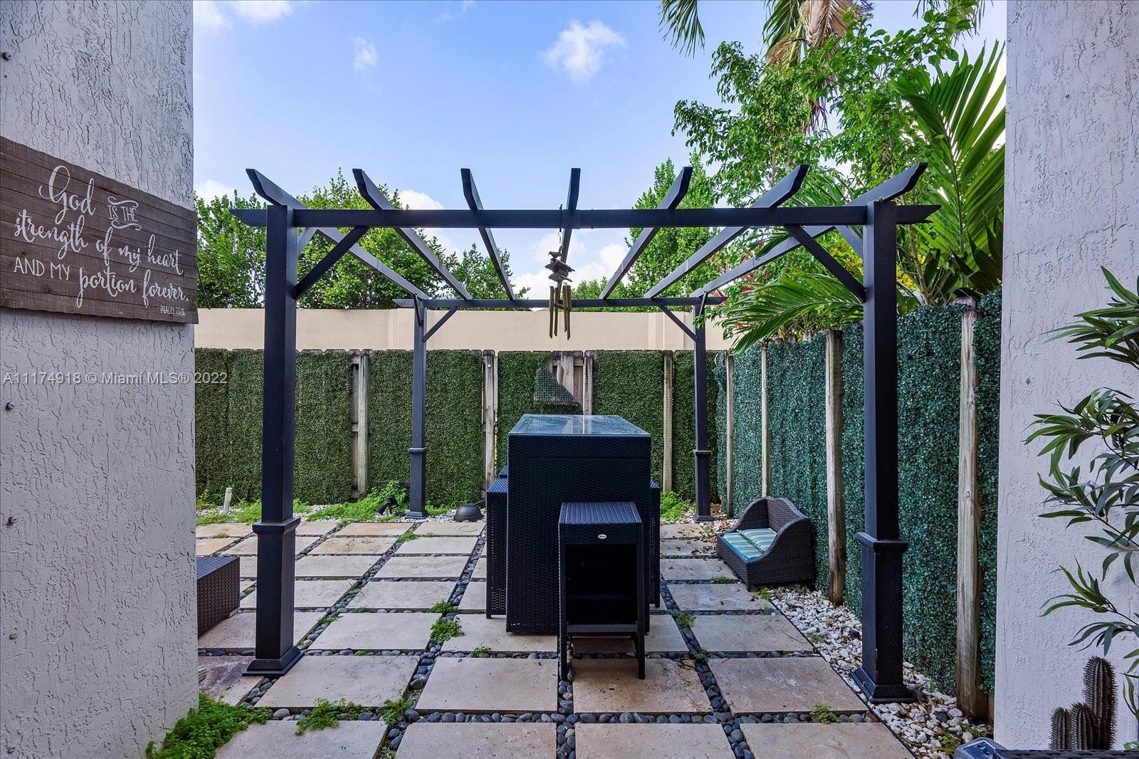 Doral Isles Doral, FL 33178 - Photo 31 of 38 a view of a patio with table and chairs potted plants with wooden floor and fence