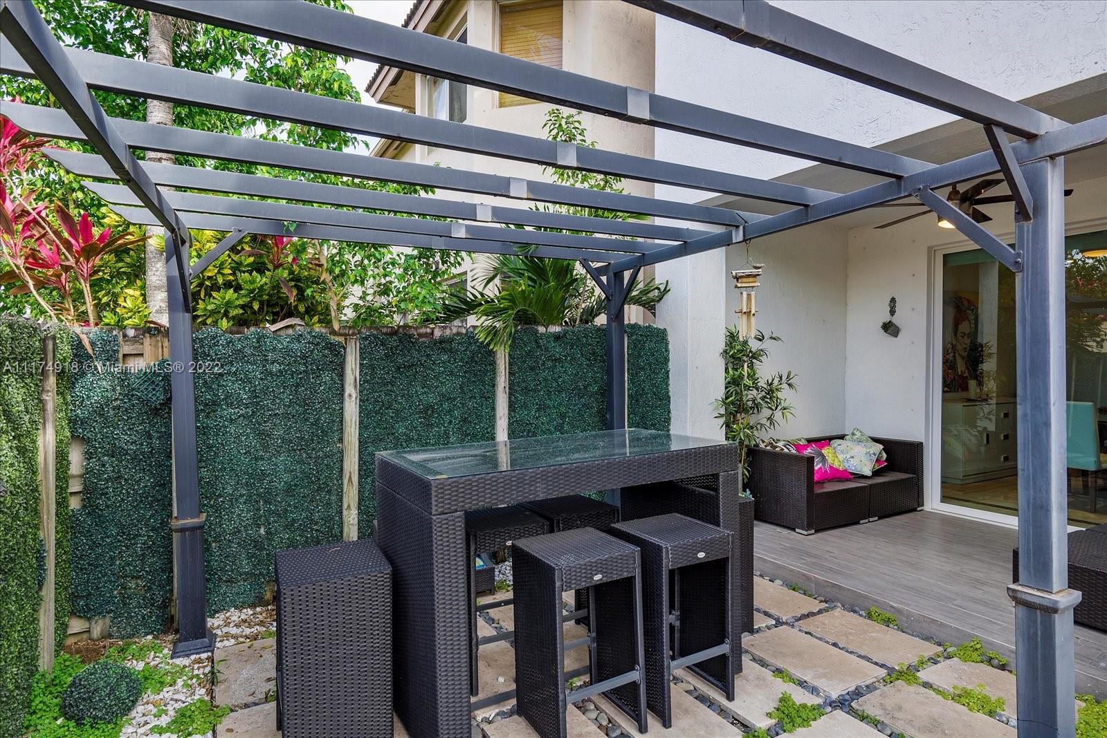 Doral Isles Doral, FL 33178 - Photo 35 of 38 a view of a porch with furniture and a yard