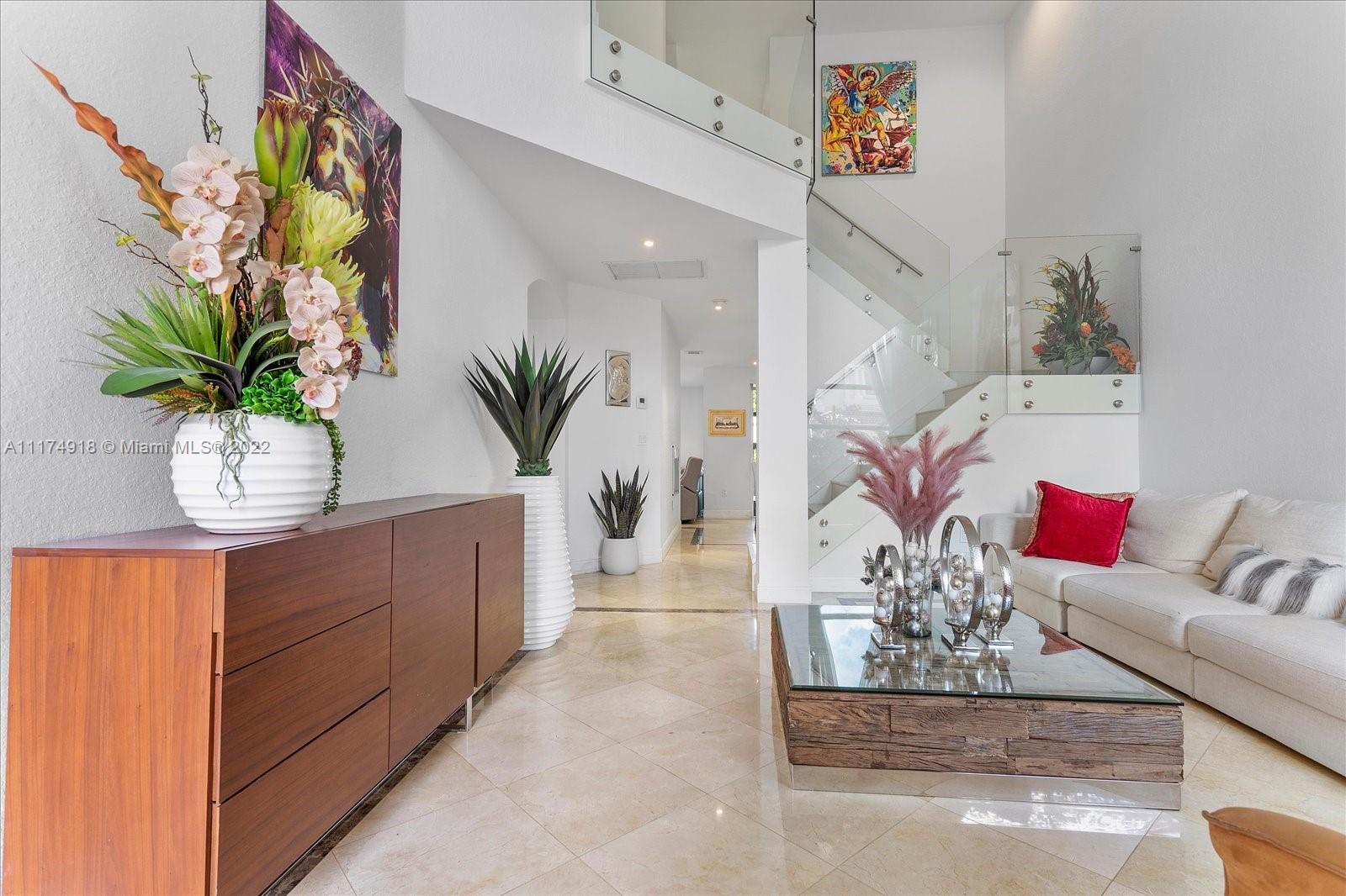 Doral Isles Doral, FL 33178 - Photo 6 of 38 a living room with furniture potted plant and a mirror