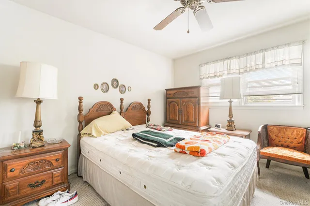 a bedroom with a bed and dresser with mirror