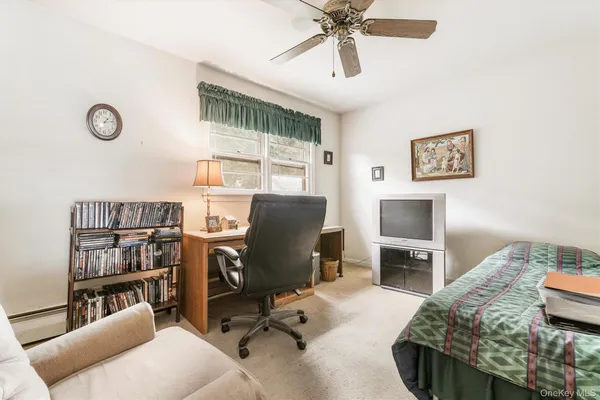 a view of a livingroom with workspace and a window