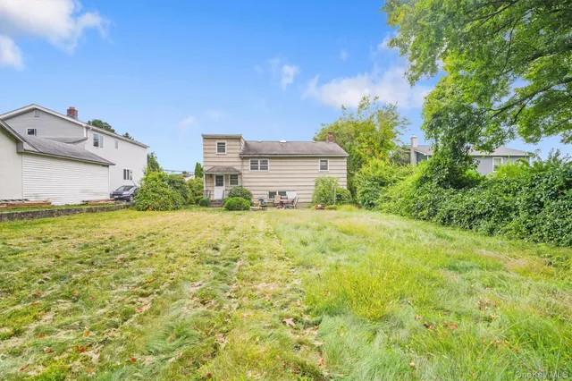 a view of a house with a yard and garage