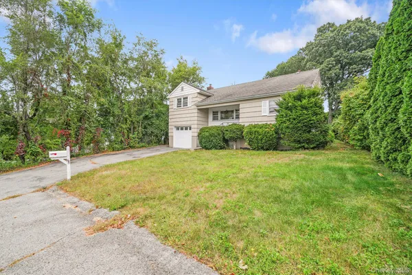 a view of a house with yard and tree s