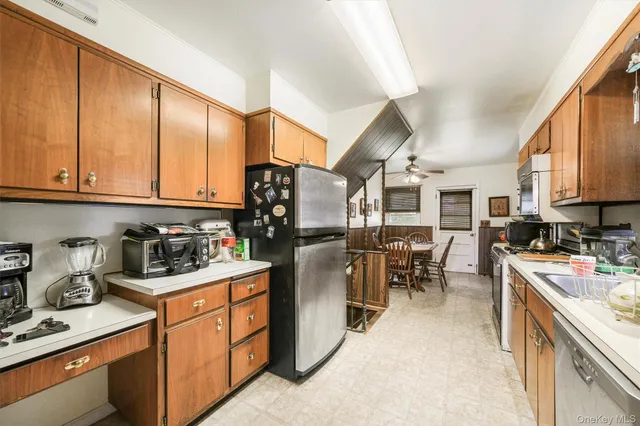 a kitchen with stainless steel appliances kitchen island granite countertop a lot of counter top space and cabinets