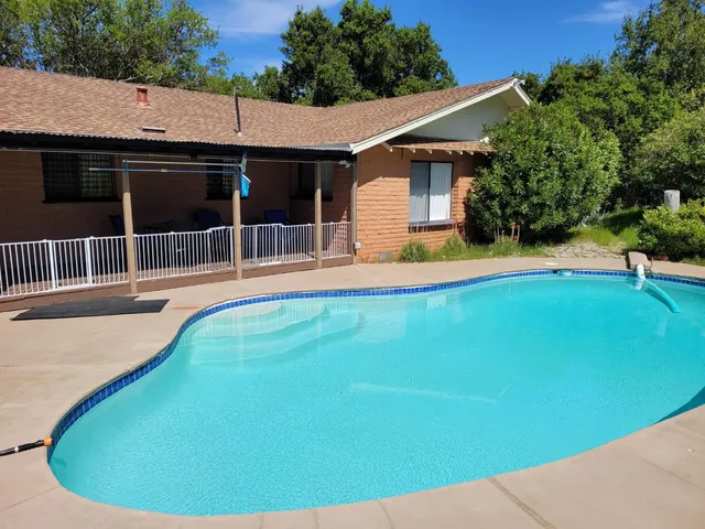 a view of a backyard with a swimming pool