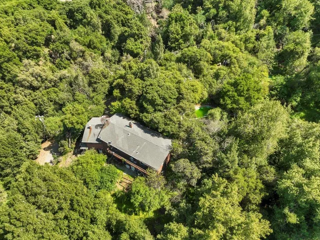 an aerial view of a house with a yard