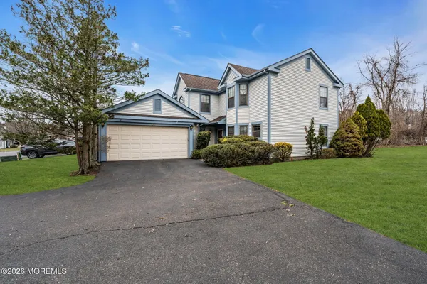 a front view of house with yard and green space