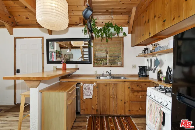 a kitchen with stainless steel appliances granite countertop a sink and a stove