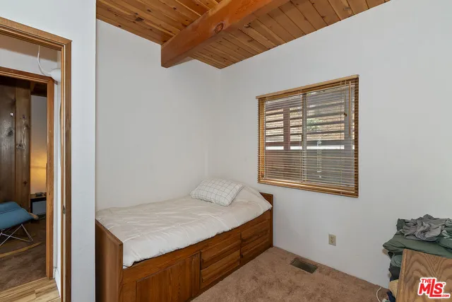 a room that has a bed and a window in it