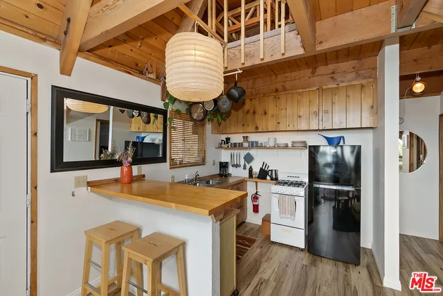 a kitchen with stainless steel appliances granite countertop a sink a stove and refrigerator