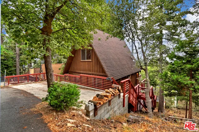 a backyard of a house with lake view and a fire pit