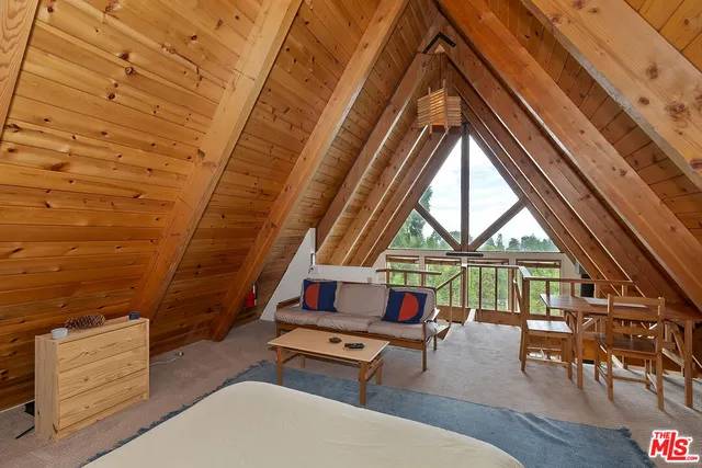a living room with furniture a rug and a window