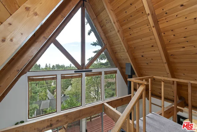 a view of room with wooden floor and door