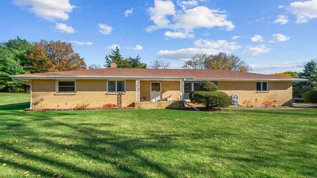 a view of a house with a backyard
