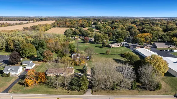 a spacious bedroom with a bed dresser and a window