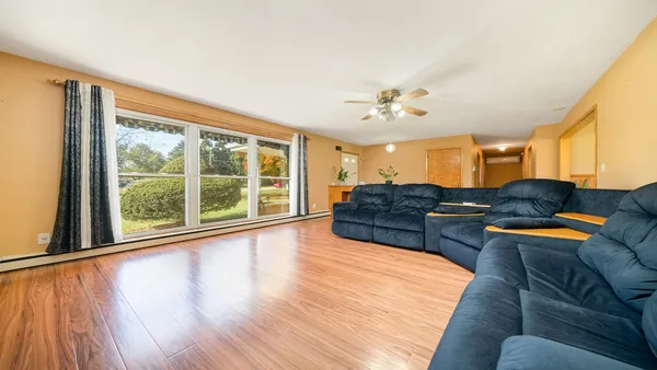 a living room with furniture and a chandelier