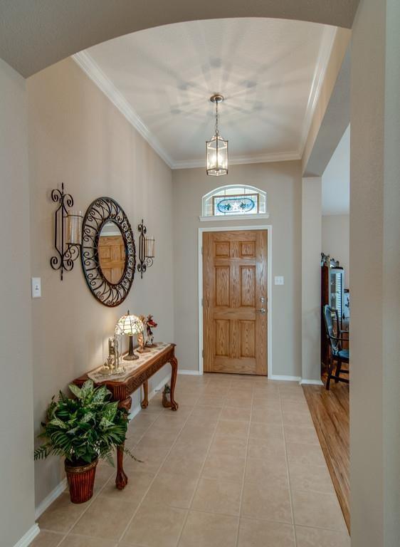 13049 Fencerow Road Fort Worth, TX 76244 - Photo 2 of 32 a living room with furniture a chandelier and a window