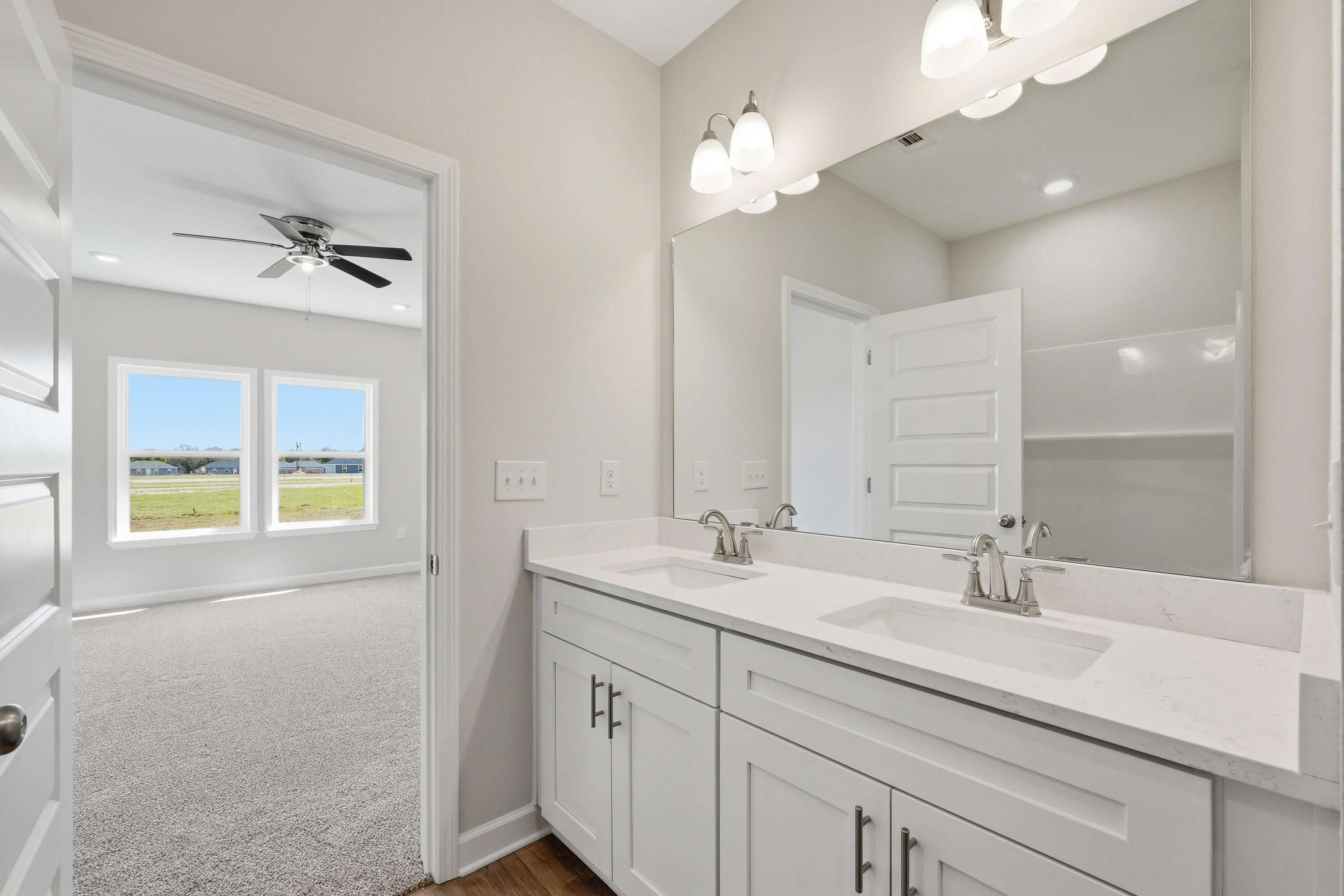 6114 Mildreds Way Crestview, FL 32539 - Photo 16 of 24 a bathroom with a sink a chandelier and a mirror