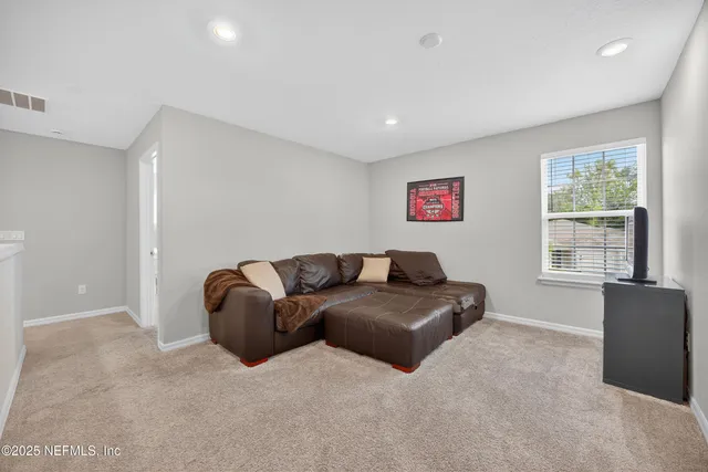 a bedroom with a bed a dresser and window