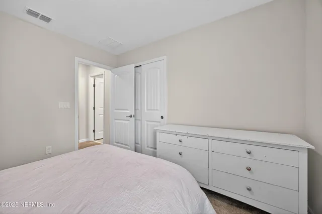 a bedroom with a bunk bed and a cabinets