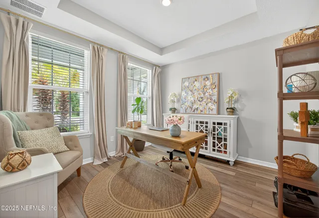 a work room with furniture and wooden floor