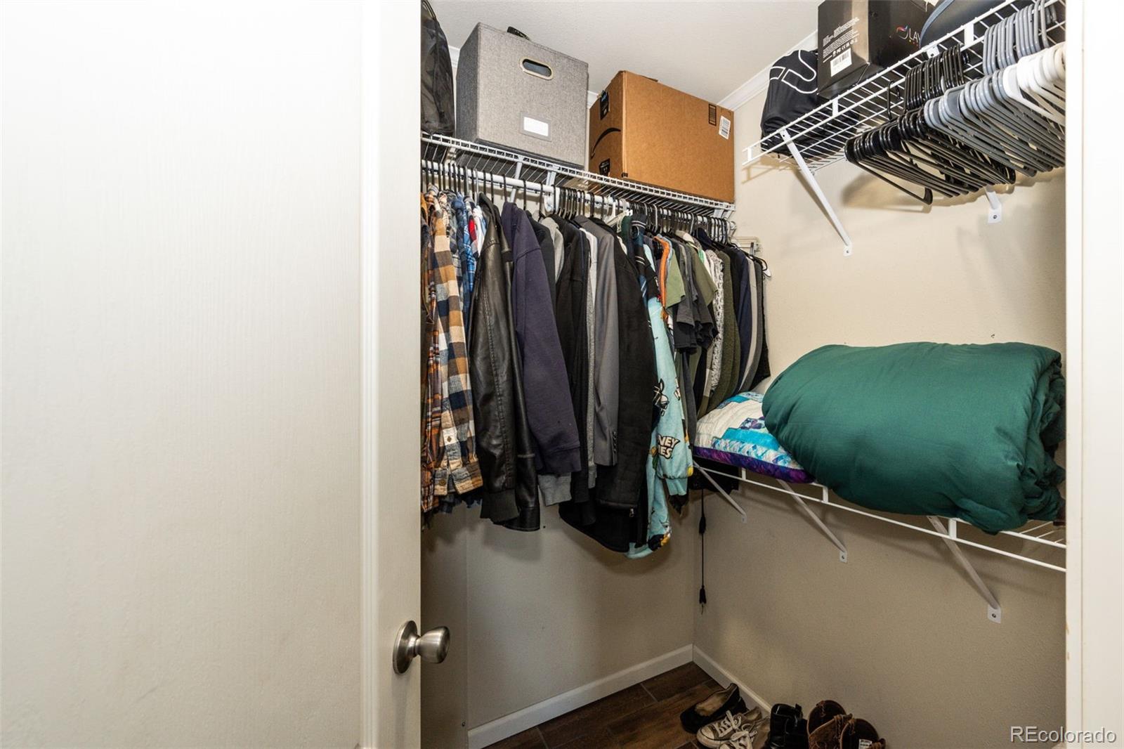 570 4th Street Bennett, CO 80102 - Photo 16 of 36 a view of walk in closet with clothes and shoes