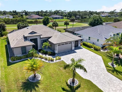a aerial view of a house with swimming pool garden and patio