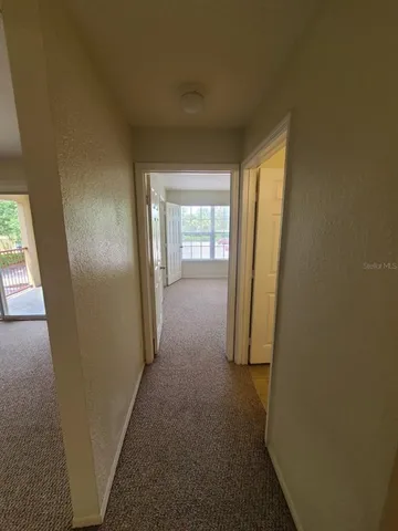 an empty room with closet and window