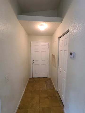 an empty room with windows and entrance