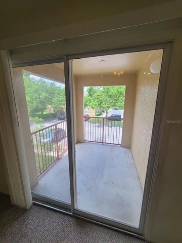 a view of a kitchen with a sink and a refrigerator