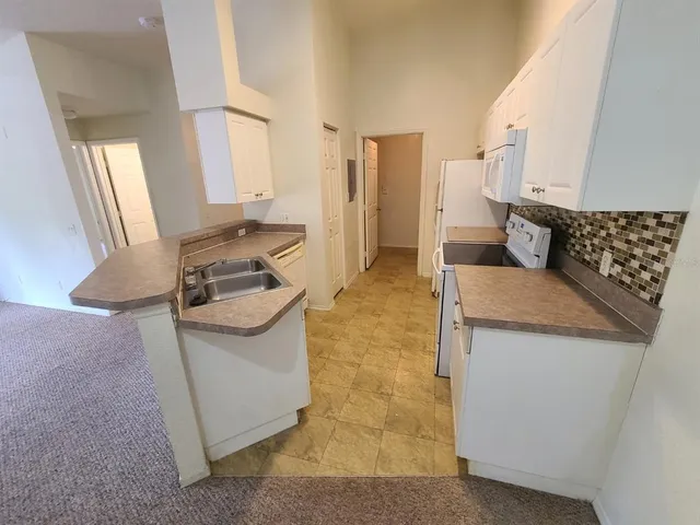 a kitchen with a sink cabinets and window