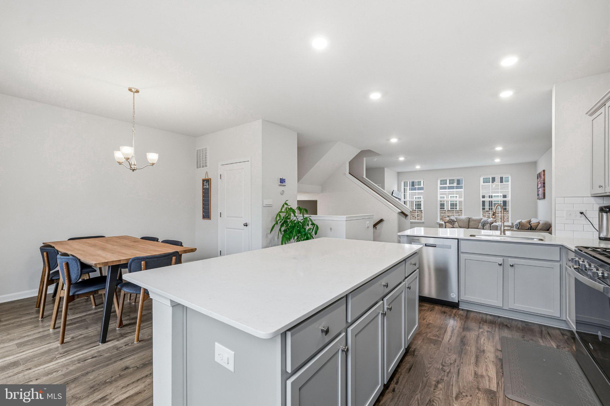 20 Sister's Farmstead Road Mount Laurel, NJ 08054 - Photo 22 of 42 a kitchen with a stove a sink a kitchen island with chairs and wooden floor