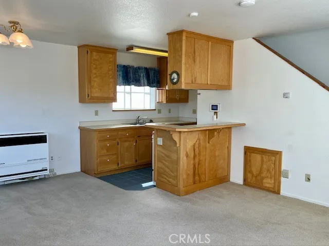 a kitchen with a sink a stove and cabinets