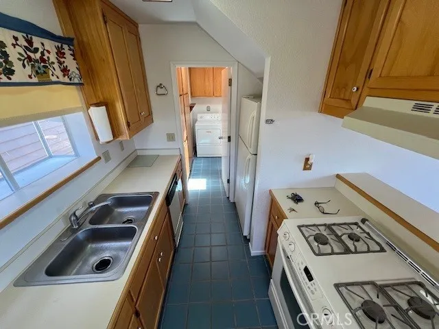 a kitchen with a stove and a refrigerator