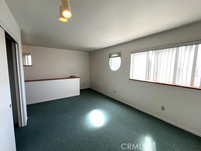 a view of an empty room and wooden floor