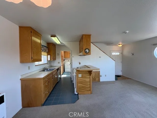 a kitchen with stainless steel appliances granite countertop a sink and a stove
