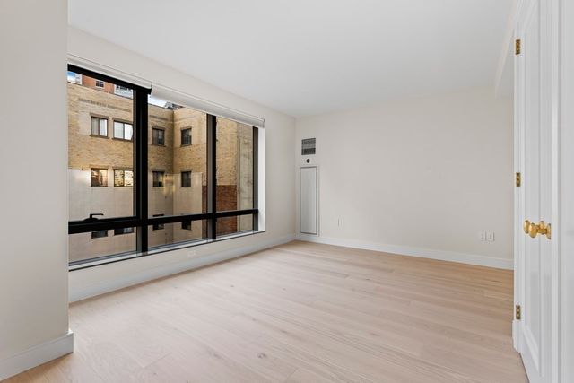 wooden floor in an empty room with windows