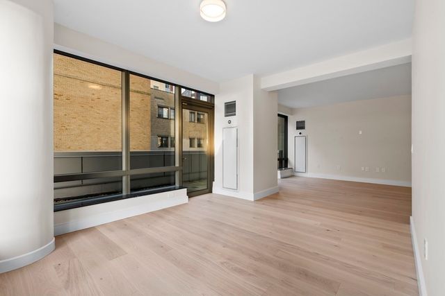 a view of wooden floor and windows in a room