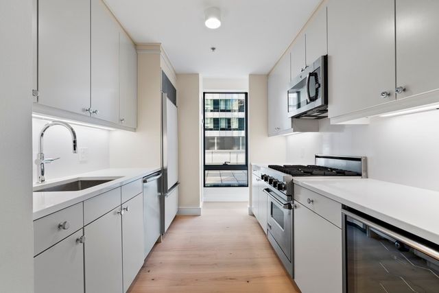 a kitchen with granite countertop a sink and cabinets