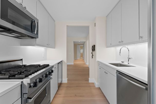 a kitchen with stainless steel appliances granite countertop a stove and a sink