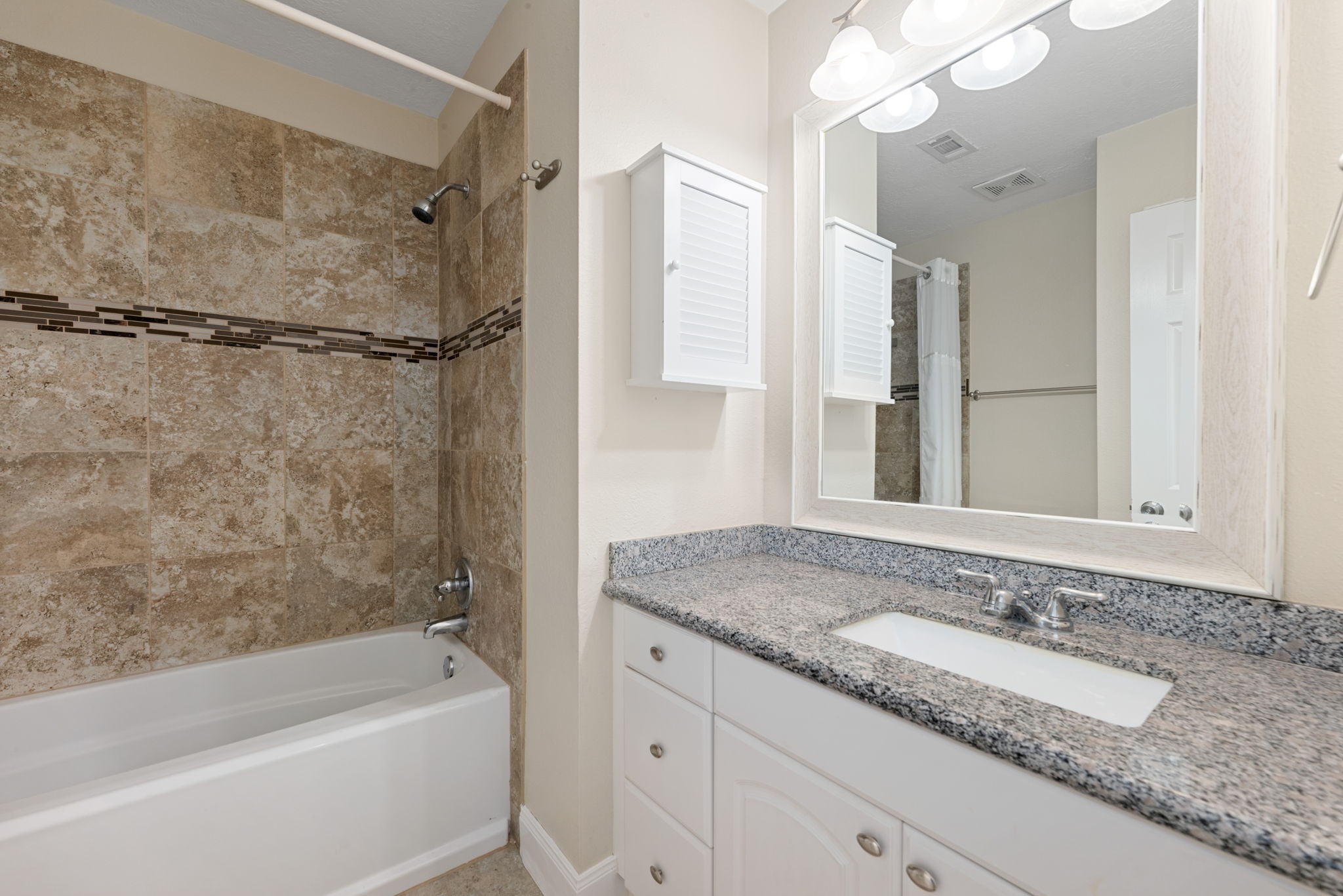1915 Mercoal Drive Spring, TX 77386 - Photo 22 of 50 Full secondary bathroom with an extended vanity, tub/shower combination, and modern finishes.